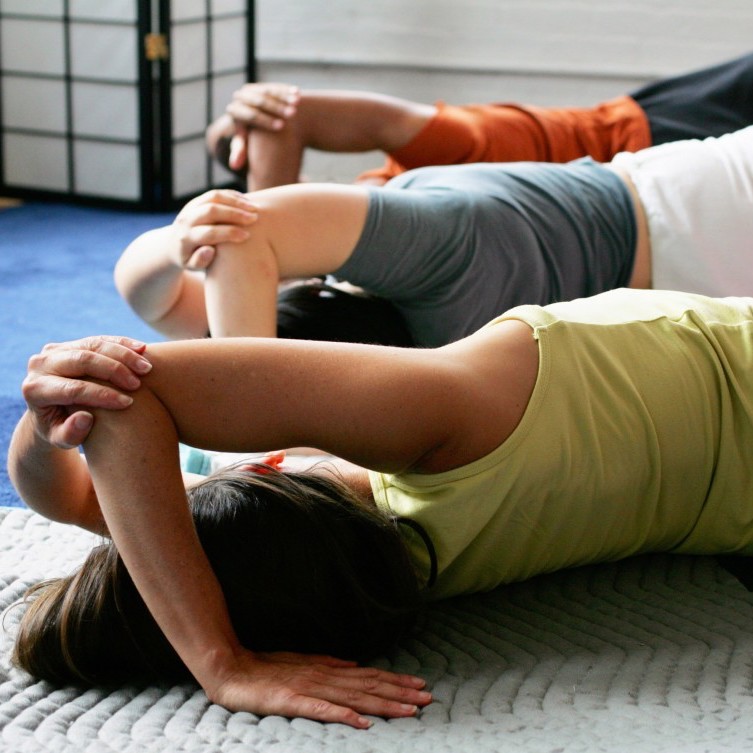 Students stretching on the floor - aches and pains - child with special needs - vitality, mobility, and stability in aging - brain trauma